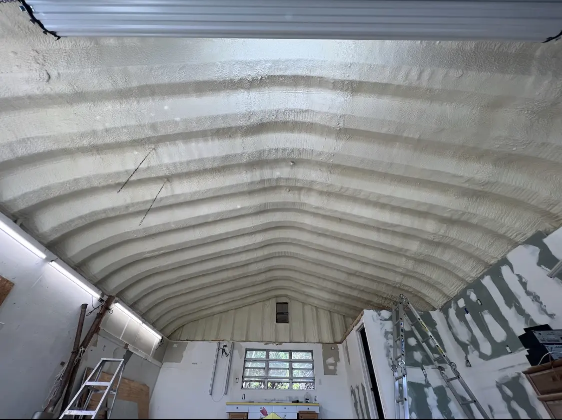 Spray polyurethane foam applied to the underside of a metal roof deck in Oneonta